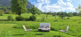 Grand jardin avec un banc et chaises de jardin